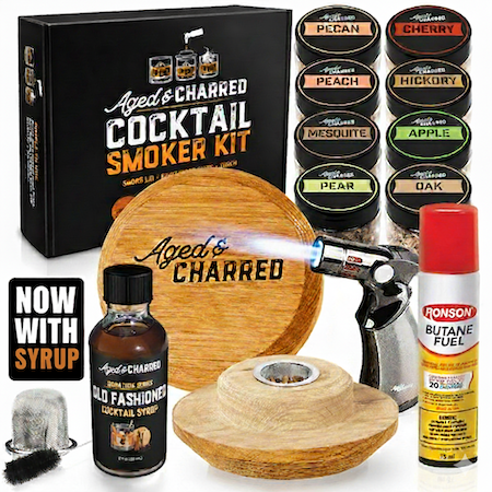 Aged & Charred cocktail smoker kit includes Smoke Lid made from 100% oak, 8 wood chips flavors, a culinary torch, butane and our Aged & Charred Signature Syrup all packaged in a handsome gift box