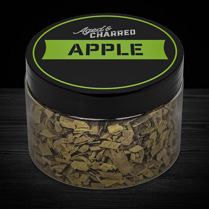 A clear container filled with apple wood chips, intended for whiskey infusion.