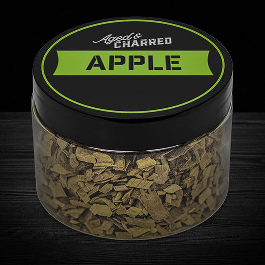 A clear container filled with apple wood chips, intended for whiskey infusion.