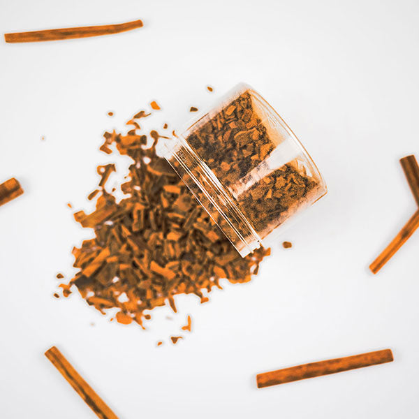 A clear container with Cinnamon flavoured wood chips, intended for whiskey infusion.