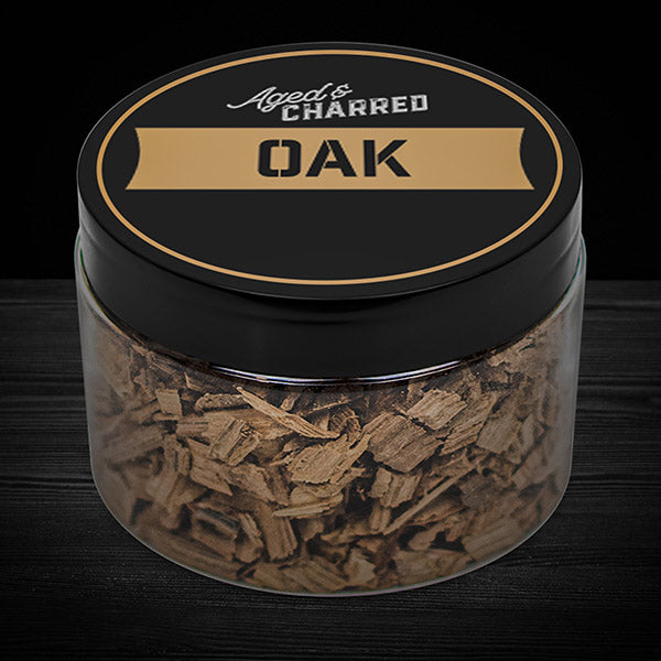 A clear container filled with oak wood chips, labeled 'Aged & Charred OAK'