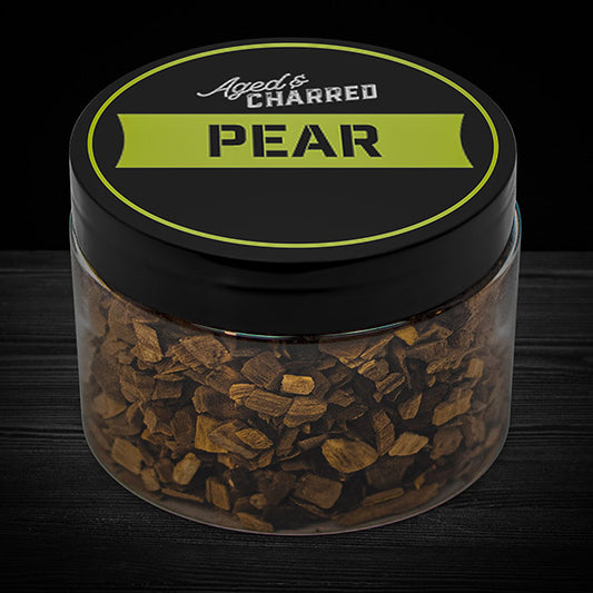 A clear container filled with pear wood chips, intended for whiskey infusion.