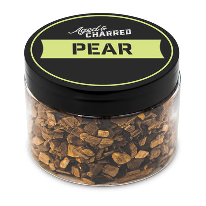 A clear container filled with pear wood chips, intended for whiskey infusion.