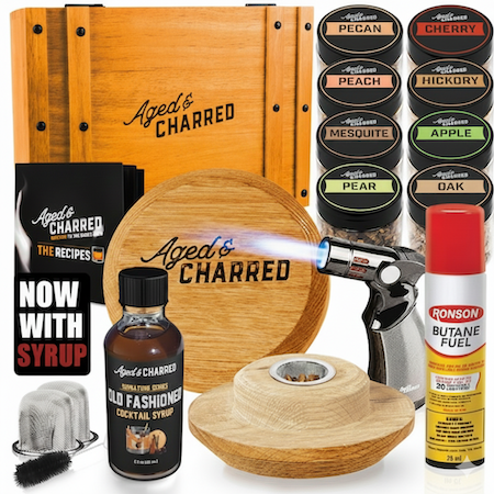 Premium cocktail smoker lid kit includes wooden box, Smoke Lid, 8 wood chip flavors, culinary torch, butane, recipe book and syrup. 